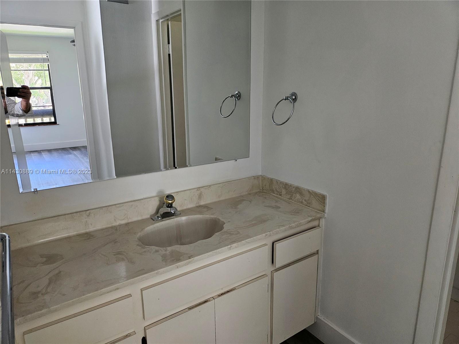 9194 Southwest 132nd Lane, Unit 1 Miami, FL 33176 - Photo 5 of 11 a bathroom with a sink and mirror