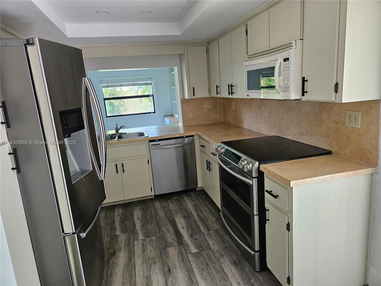 9194 Southwest 132nd Lane, Unit 1 Miami, FL 33176 - Photo 9 of 11 a kitchen with a sink stove and refrigerator