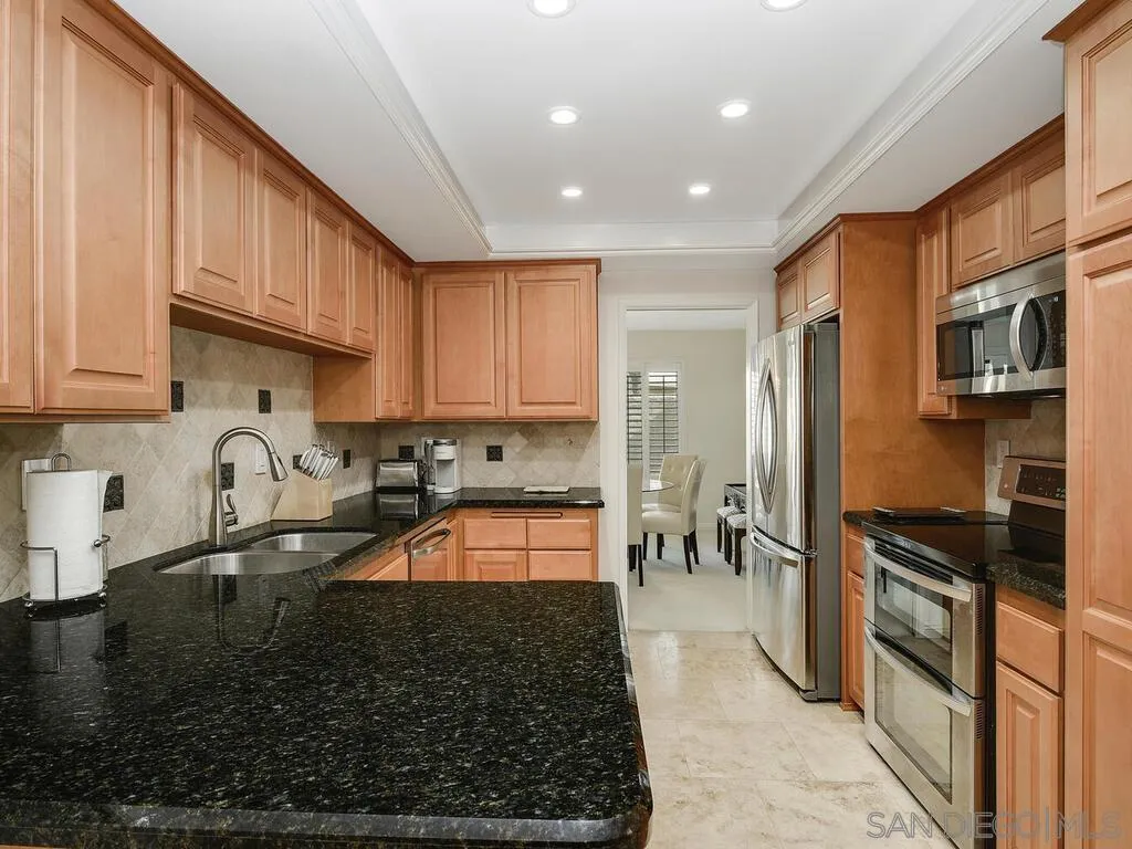 16055 Vista De Golf Rancho Santa Fe, CA 92091 - Photo 11 of 35 a kitchen with granite countertop a refrigerator and a stove top oven