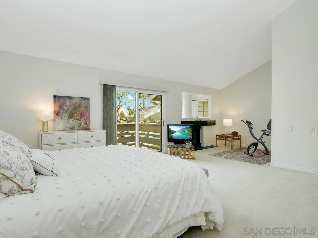 16055 Vista De Golf Rancho Santa Fe, CA 92091 - Photo 15 of 35 a spacious bedroom with a bed a table and balcony view