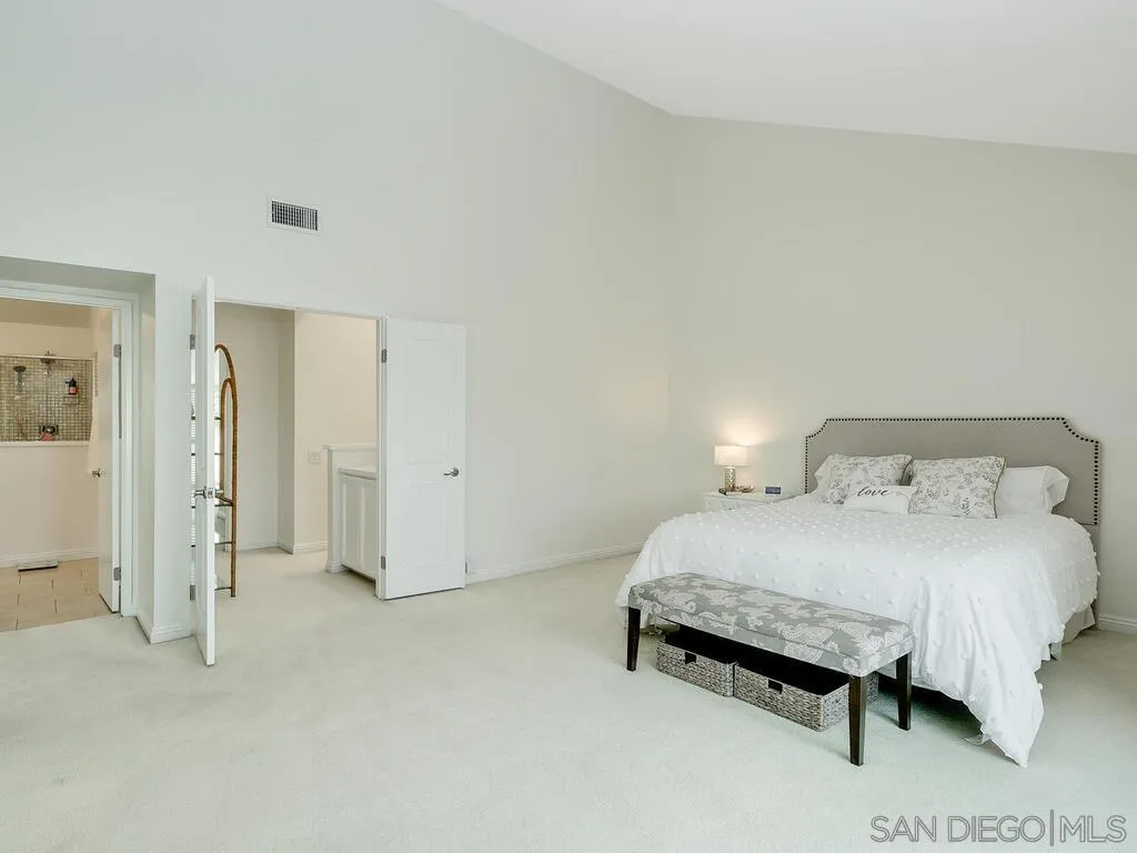 16055 Vista De Golf Rancho Santa Fe, CA 92091 - Photo 16 of 35 a spacious bedroom with a bed and a table