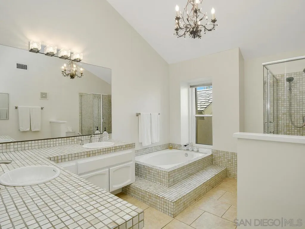 16055 Vista De Golf Rancho Santa Fe, CA 92091 - Photo 20 of 35 a bathroom with a double vanity sink a mirror a bathtub and a window