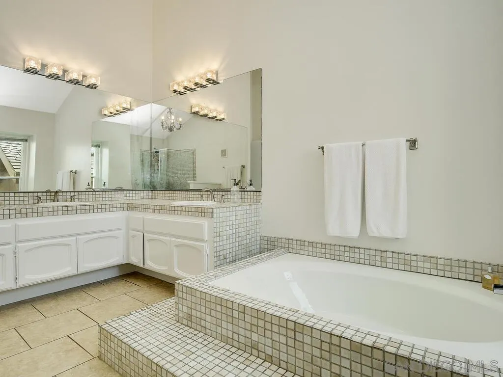 16055 Vista De Golf Rancho Santa Fe, CA 92091 - Photo 22 of 35 a bathroom with a granite countertop sink a mirror and a bathtub