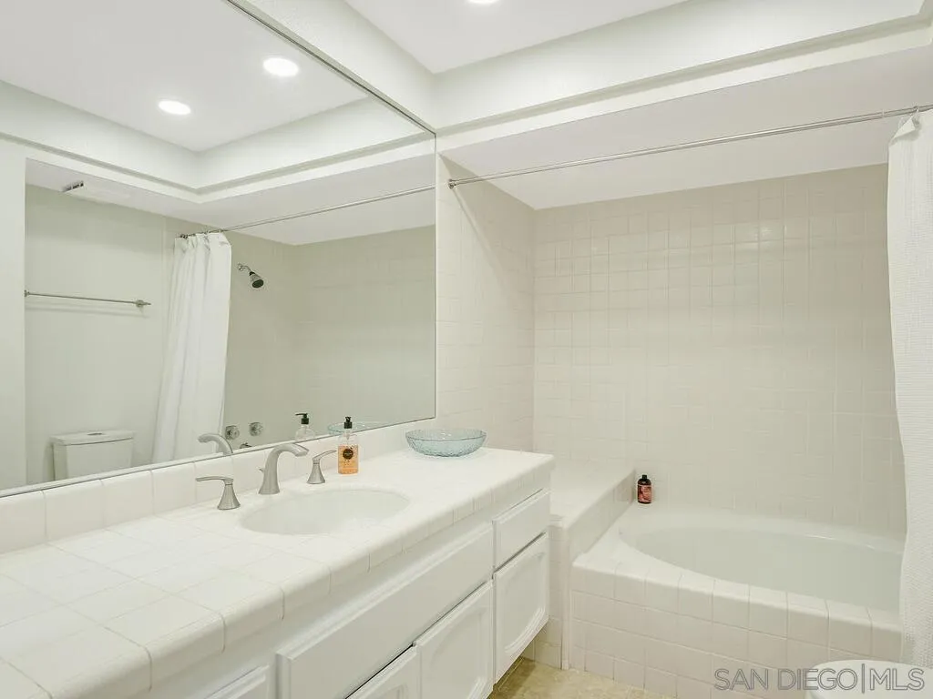 16055 Vista De Golf Rancho Santa Fe, CA 92091 - Photo 27 of 35 a bathroom with a tub a sink and a mirror