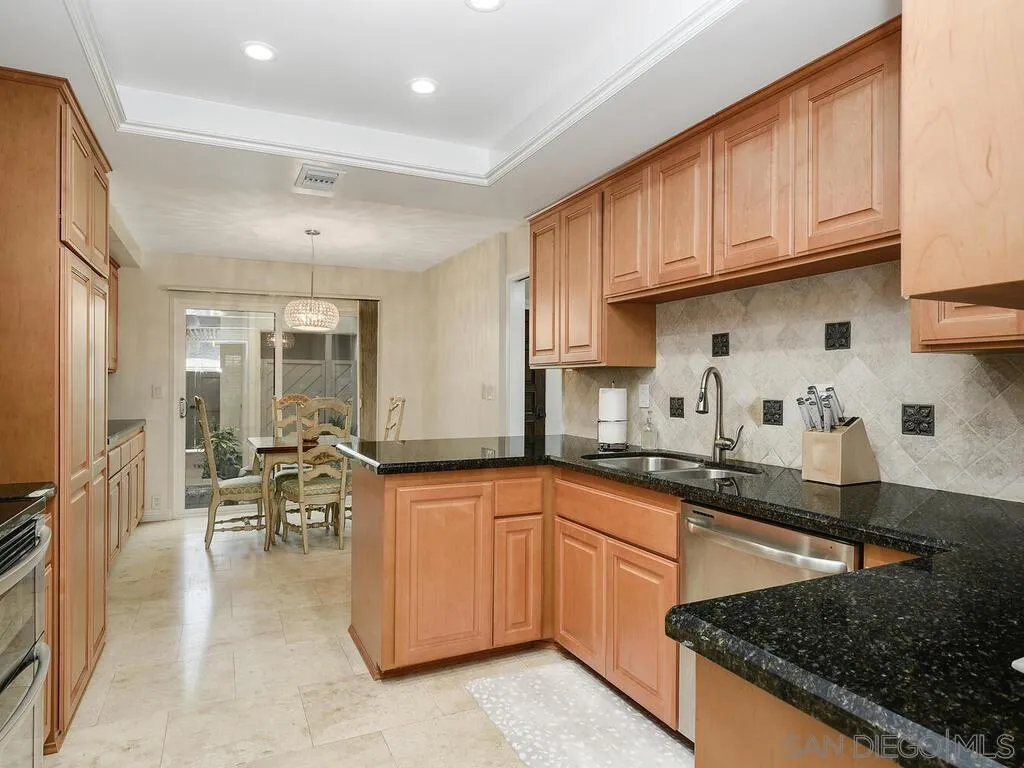 16055 Vista De Golf Rancho Santa Fe, CA 92091 - Photo 10 of 35 a kitchen with granite countertop a sink a stove and cabinets