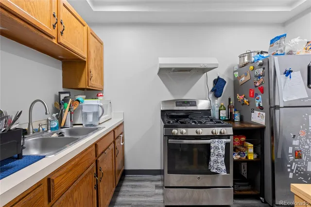 a kitchen with stainless steel appliances granite countertop a stove and a sink