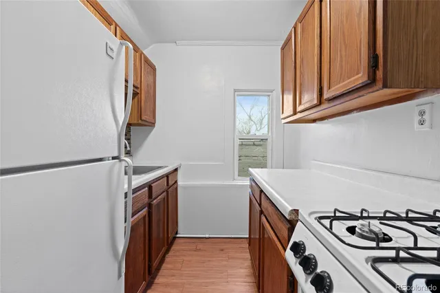 a kitchen with stainless steel appliances granite countertop a stove and a refrigerator