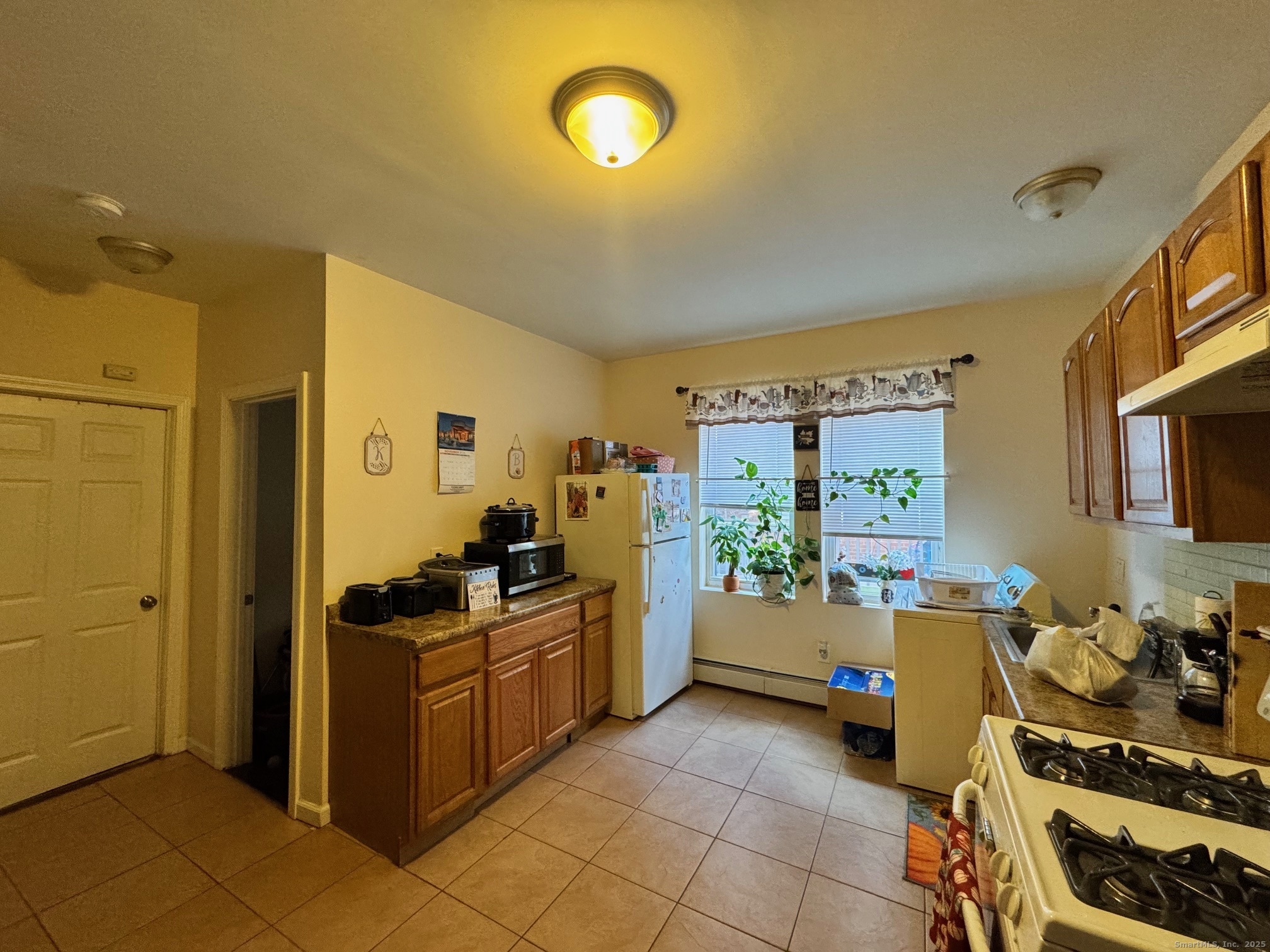 204 Magnolia Street, Unit 2S Hartford, CT 06112 - Photo 5 of 11 a view of a kitchen with fridge and workspace