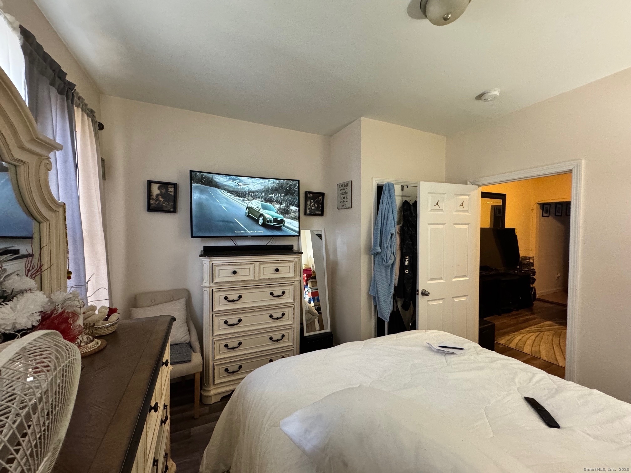 204 Magnolia Street, Unit 2S Hartford, CT 06112 - Photo 9 of 11 a bedroom with a bed and a flat screen tv