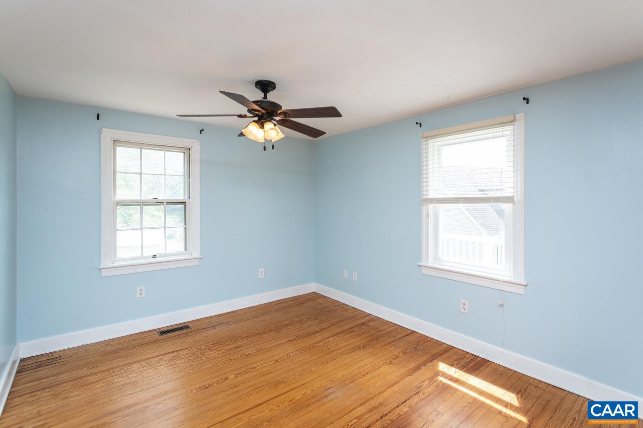 703 Monroe Street Staunton, VA 24401 - Photo 15 of 46 a view of an empty room with a window and a chandelier fan
