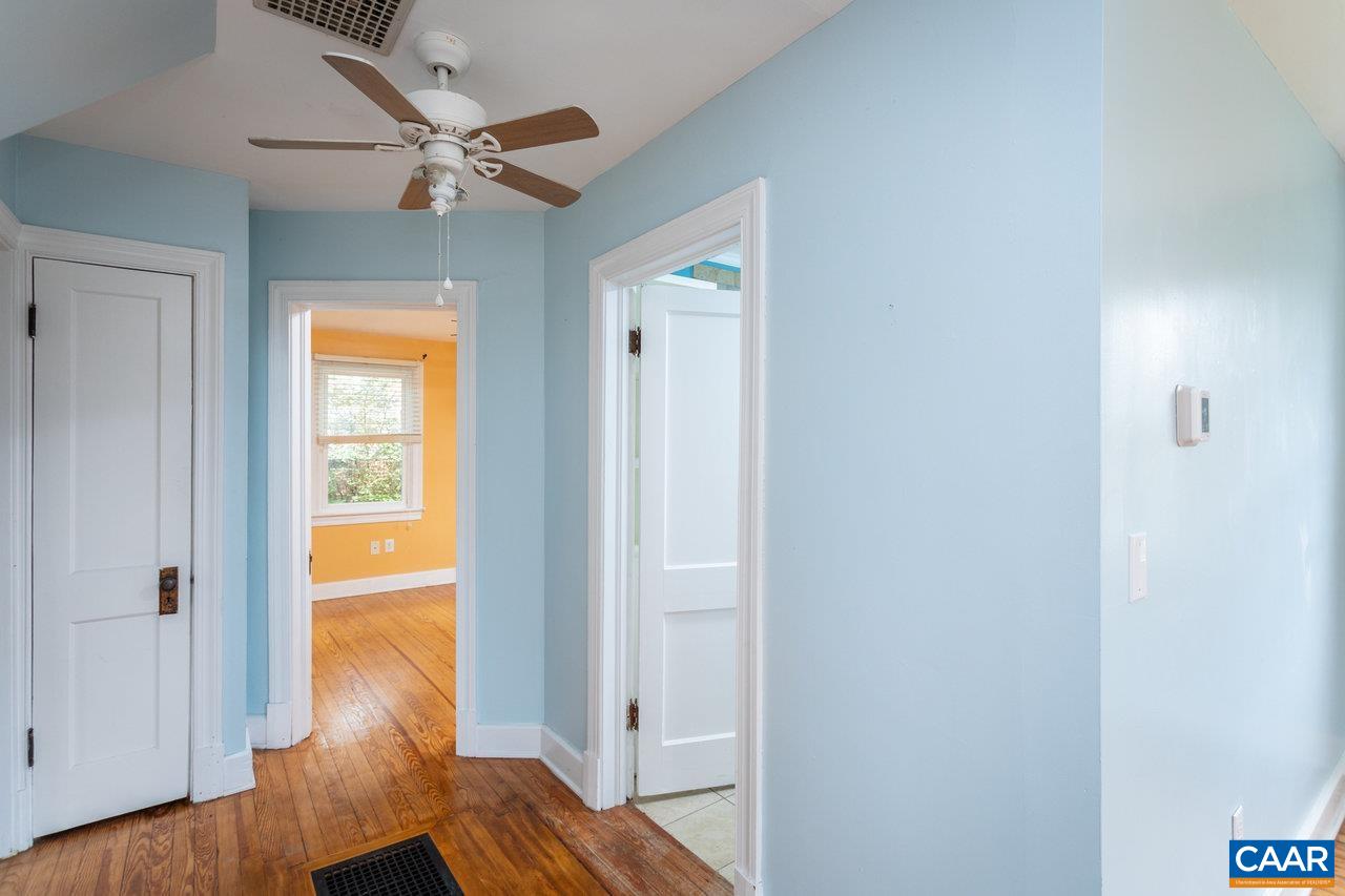 703 Monroe Street Staunton, VA 24401 - Photo 17 of 46 a view of a hallway with wooden floor and a bathroom
