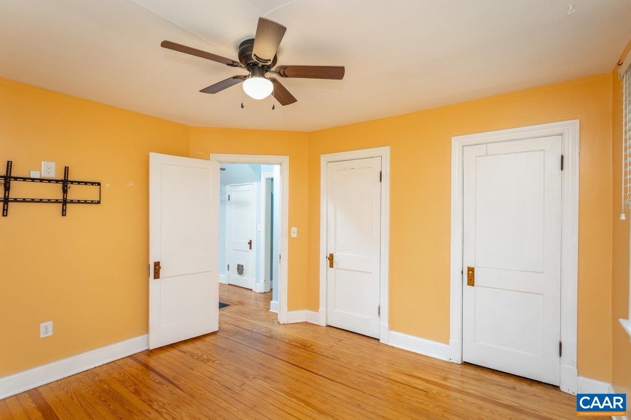 703 Monroe Street Staunton, VA 24401 - Photo 20 of 46 a view of a livingroom with wooden floor and a ceiling fan