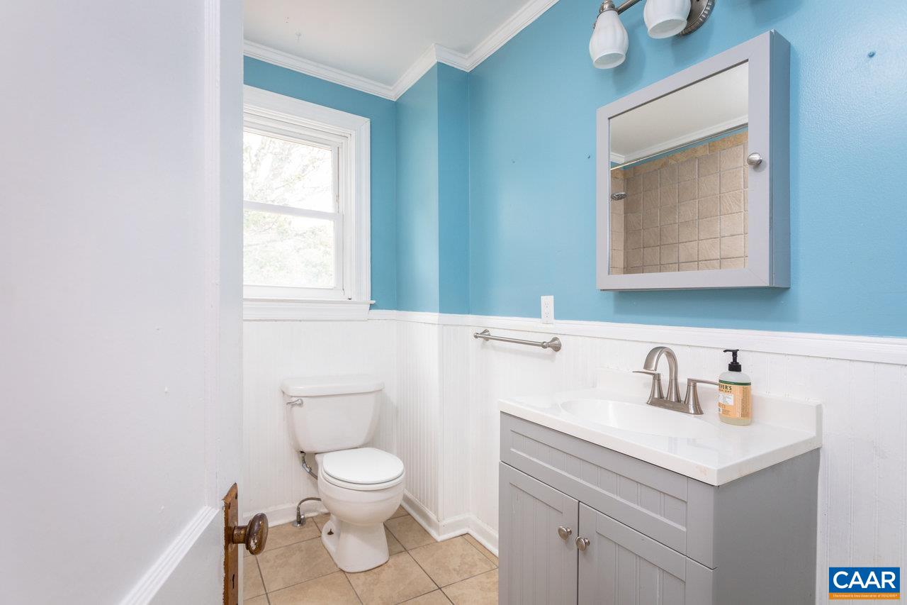 703 Monroe Street Staunton, VA 24401 - Photo 21 of 46 a bathroom with a toilet a sink and mirror
