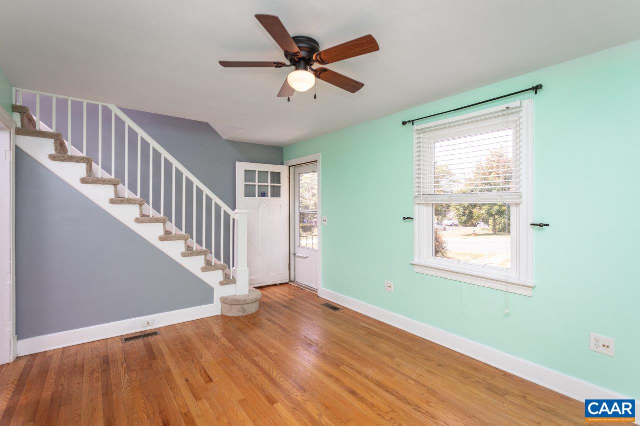 703 Monroe Street Staunton, VA 24401 - Photo 4 of 46 a view of an empty room with wooden floor and a window