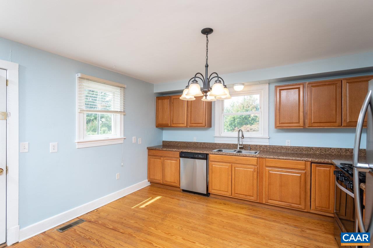 703 Monroe Street Staunton, VA 24401 - Photo 8 of 46 a kitchen with stainless steel appliances granite countertop a sink a window and wooden floor
