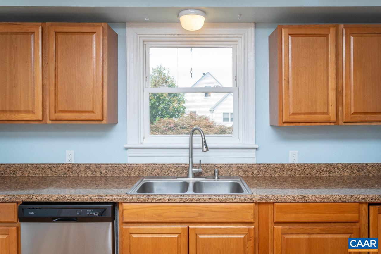 703 Monroe Street Staunton, VA 24401 - Photo 9 of 46 a kitchen with granite countertop cabinets sink and window