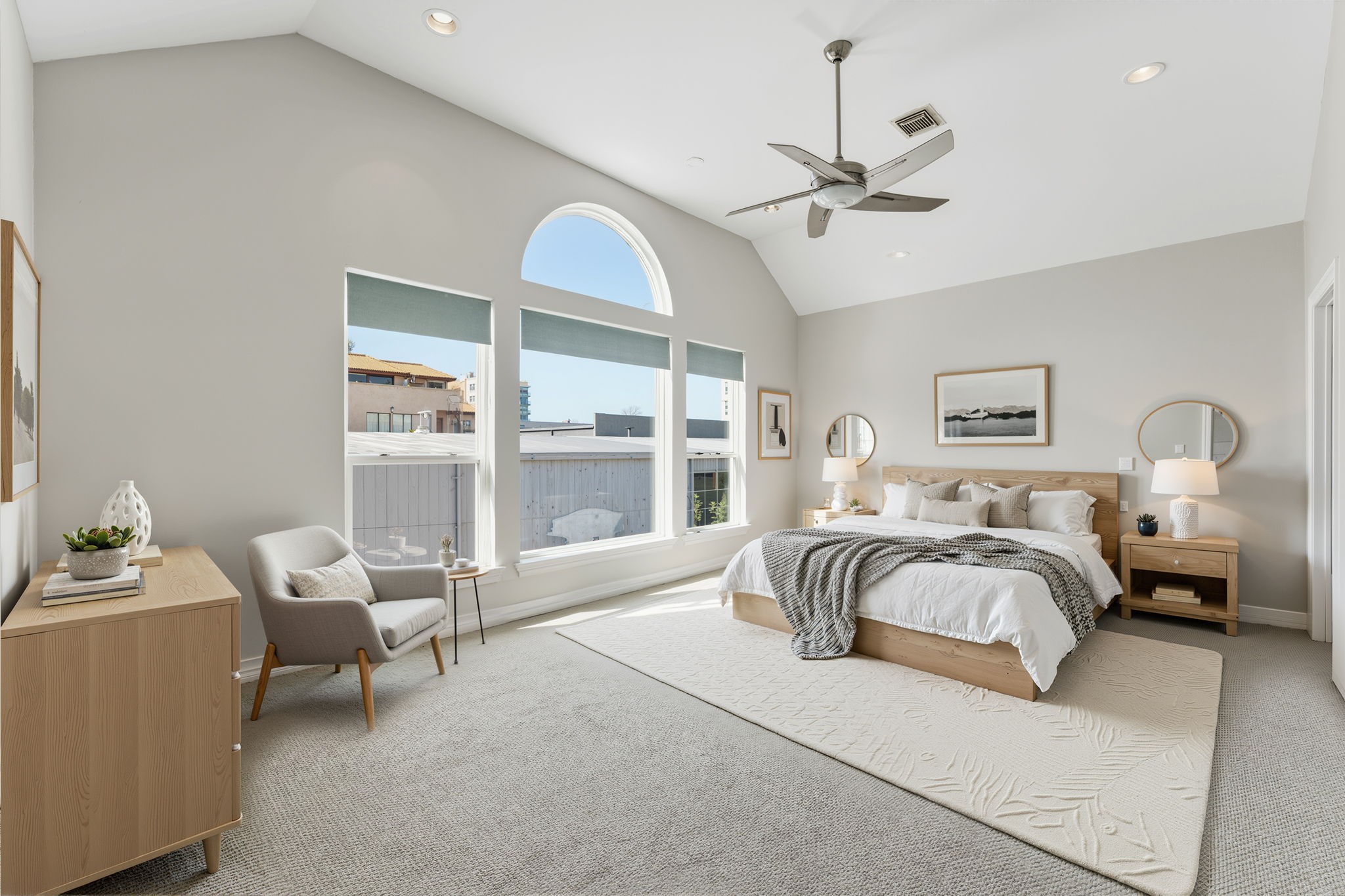827 Rosine Street Houston, TX 77019 - Photo 3 of 50 Immerse yourself in this bright, virtually staged bedroom featuring vaulted ceilings, ample natural light, and stylish furnishings that invite relaxation and comfort.
