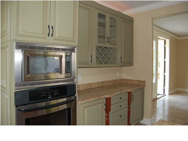 492 West Harborview Road Santa Rosa Beach, FL 32459 - Photo 7 of 16 a kitchen with a stove oven and cabinets