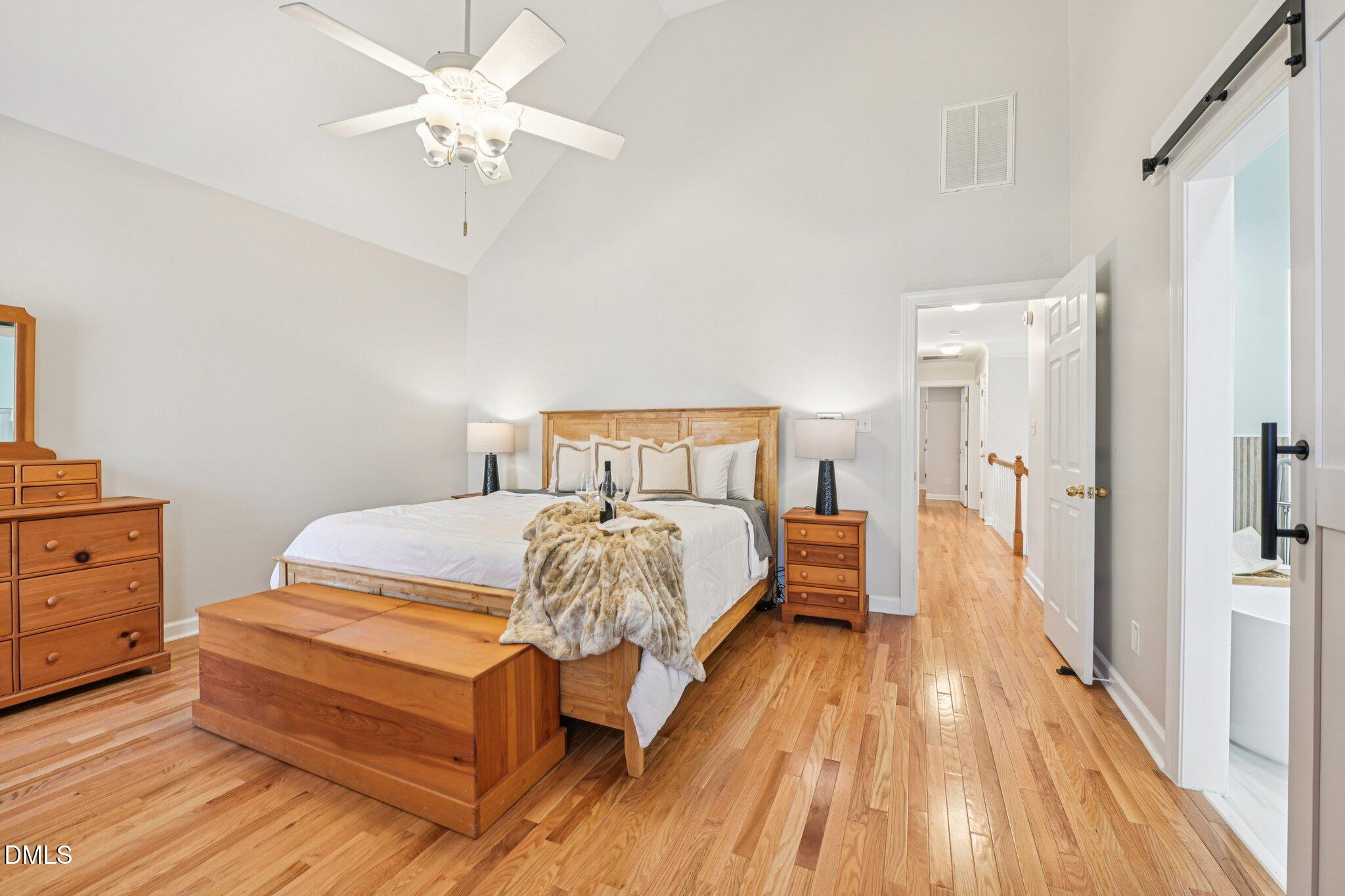2013 Kinleys Way Raleigh, NC 27613 - Photo 26 of 68 a spacious bedroom with a bed and a chandelier
