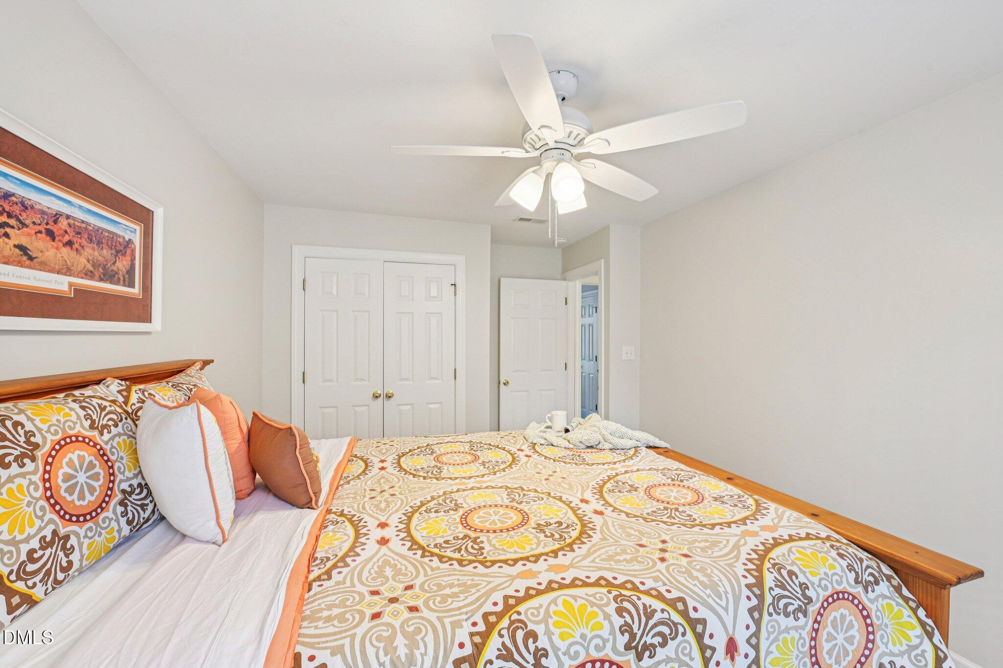 2013 Kinleys Way Raleigh, NC 27613 - Photo 37 of 68 a bedroom with a bed and a chandelier