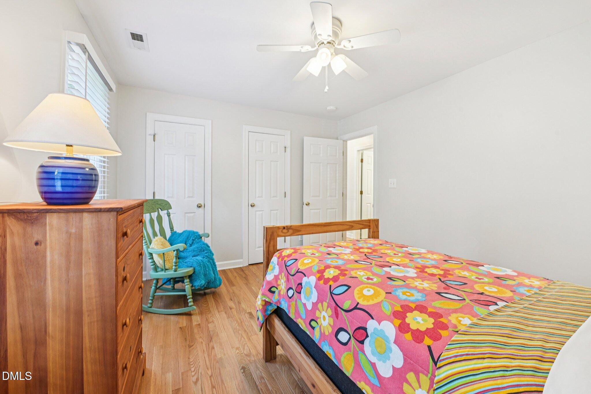 2013 Kinleys Way Raleigh, NC 27613 - Photo 39 of 68 a bedroom with a bed and a chandelier