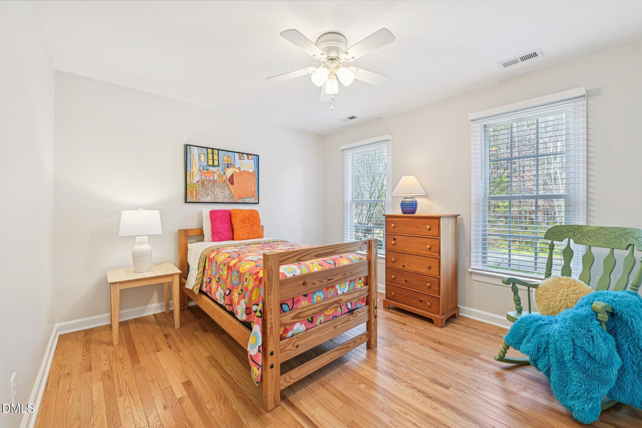 2013 Kinleys Way Raleigh, NC 27613 - Photo 40 of 68 a bedroom with a bed and a chandelier