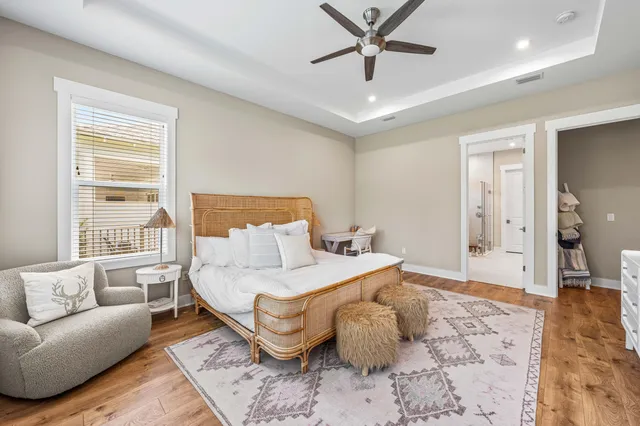 a bedroom with a large bed couch and a window