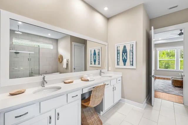a spacious bathroom with a granite countertop sink and a mirror