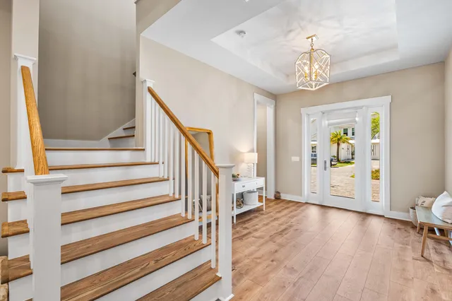 a view of a livingroom with wooden floor and furniture