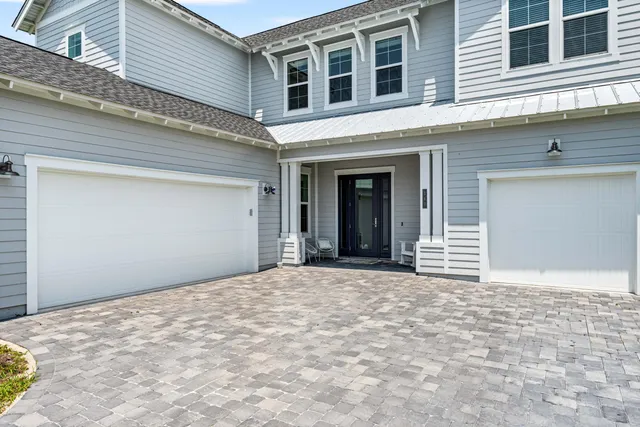 a view of a house with a yard and garage