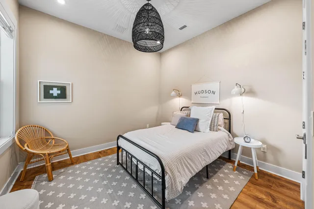 a bedroom with a bed and a chair