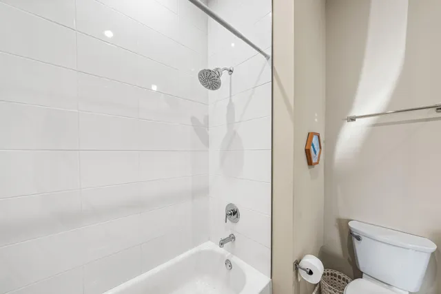 a bathroom with a toilet and a bathtub