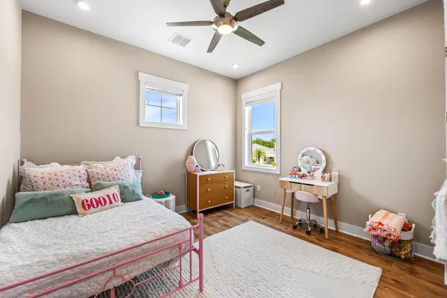 a bedroom with a bed and wooden floor