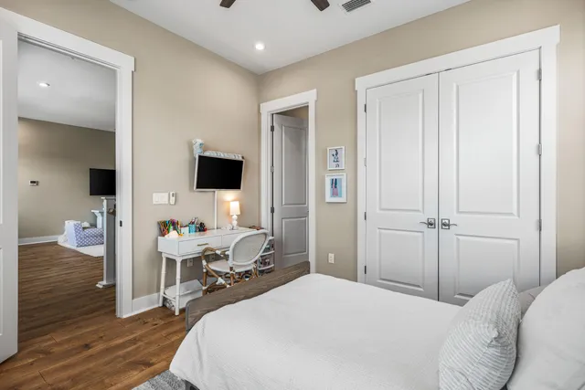 a bedroom with a bed and a large window