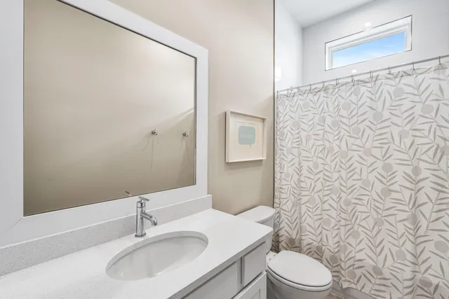 a living room with patio furniture and a flat screen tv