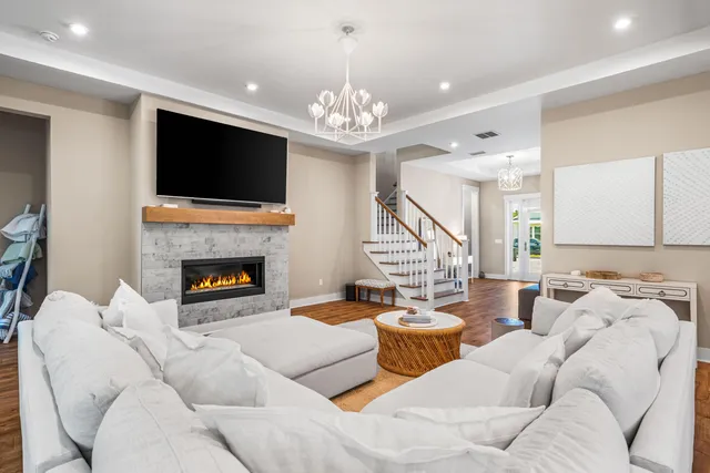 a living room with furniture a flat screen tv and a fireplace