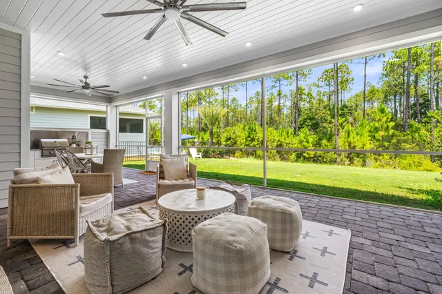 a living room with patio area and garden view