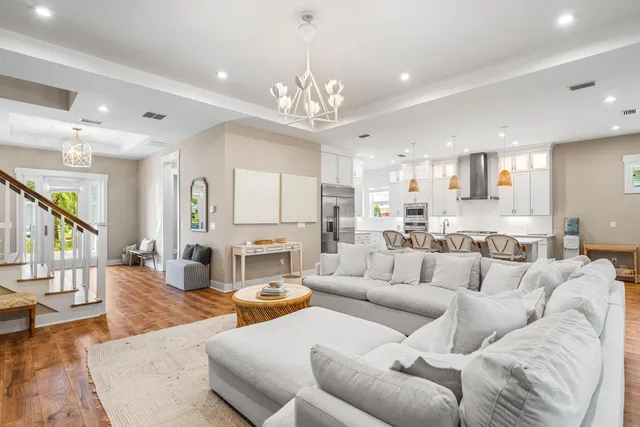 a living room with furniture or kitchen and a chandelier