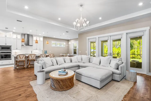 a living room with furniture and a chandelier