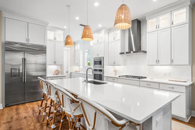 a kitchen with stainless steel appliances granite countertop a sink a stove and a refrigerator