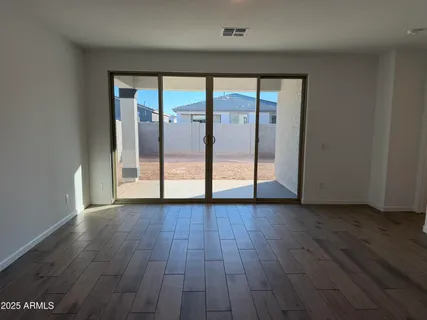 an empty room with wooden floor and door