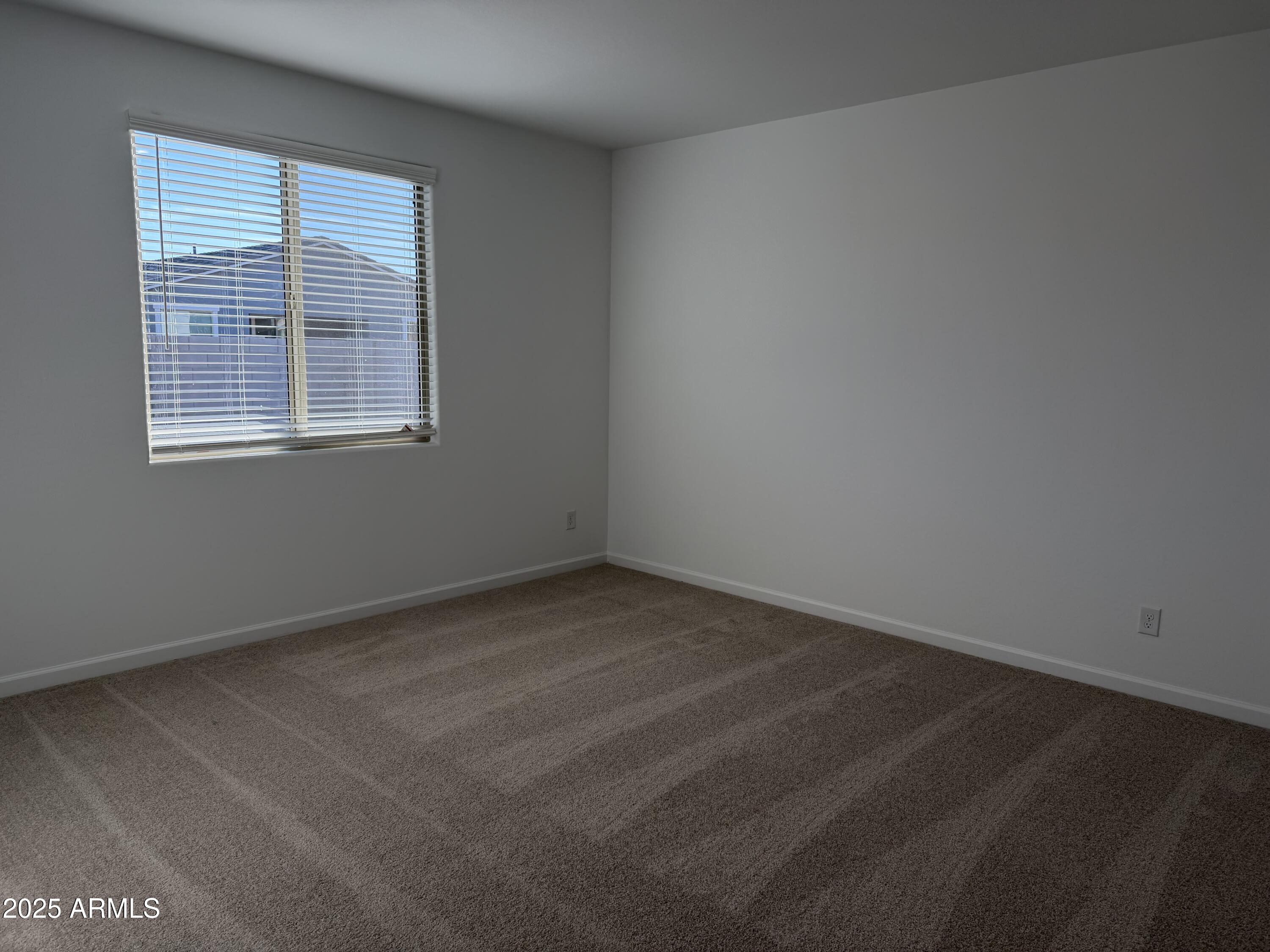 5533 West Buist Avenue Laveen, AZ 85339 - Photo 16 of 42 an empty room with a window