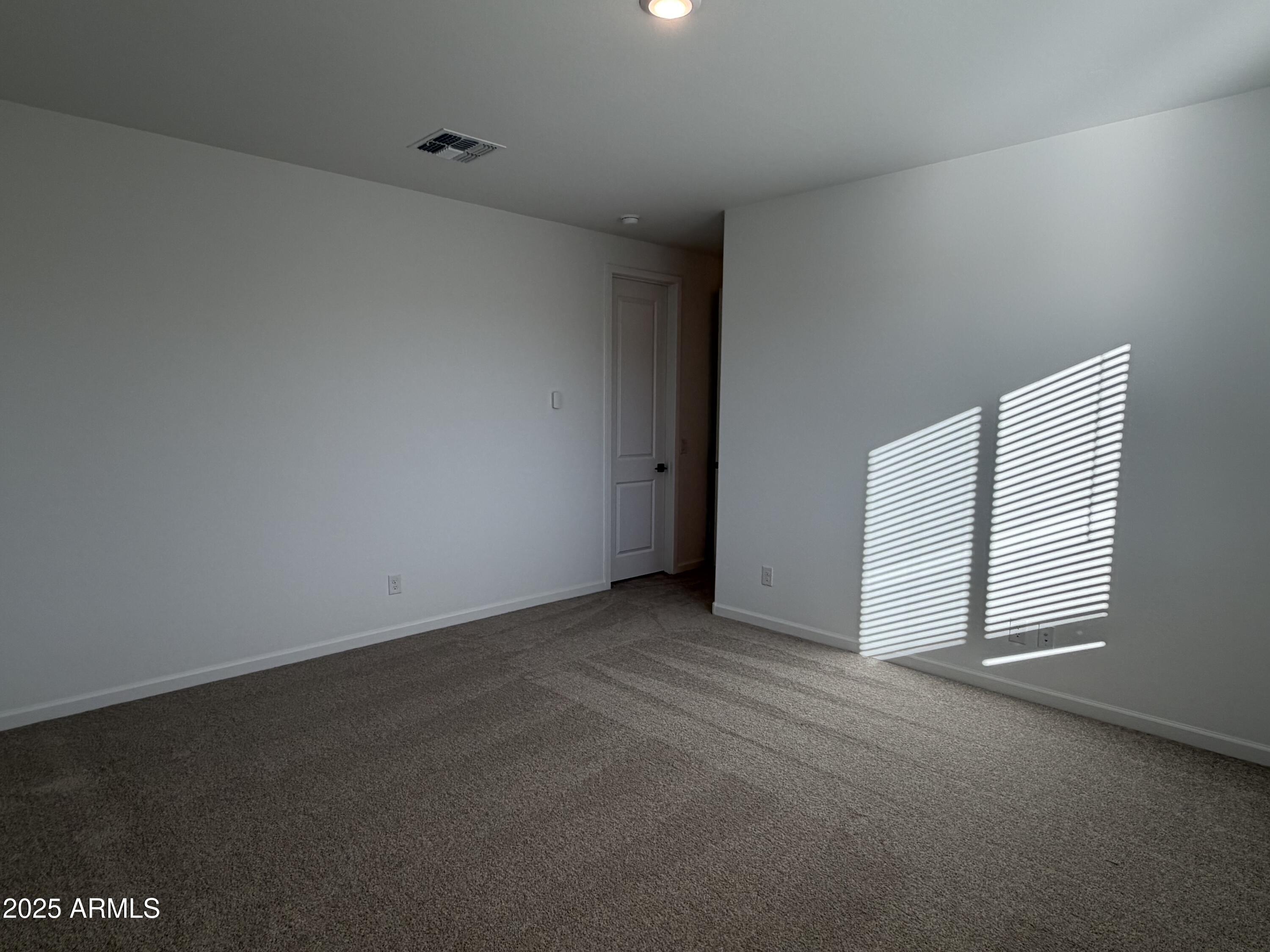 5533 West Buist Avenue Laveen, AZ 85339 - Photo 17 of 42 an empty room with windows