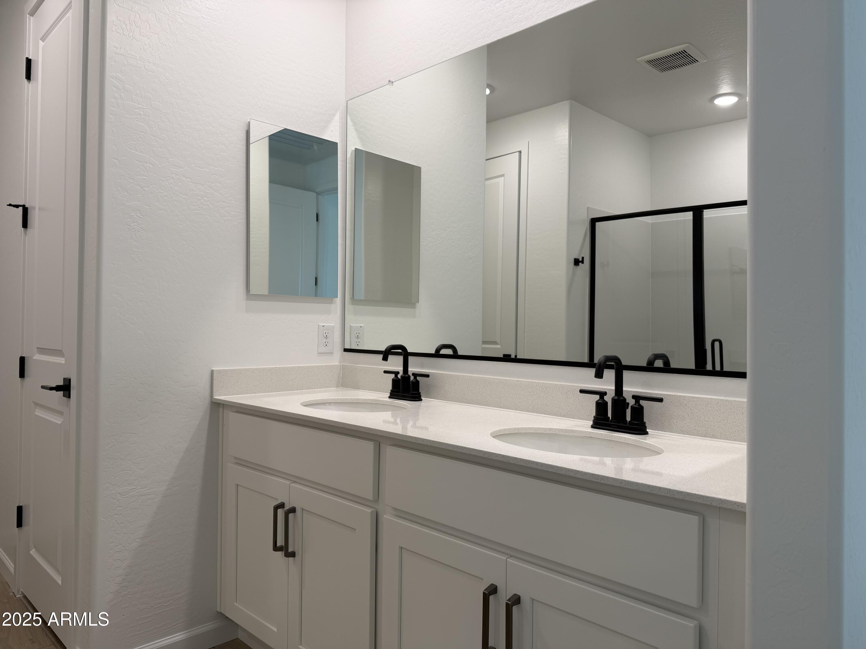 5533 West Buist Avenue Laveen, AZ 85339 - Photo 19 of 42 a bathroom with double sink and a mirror