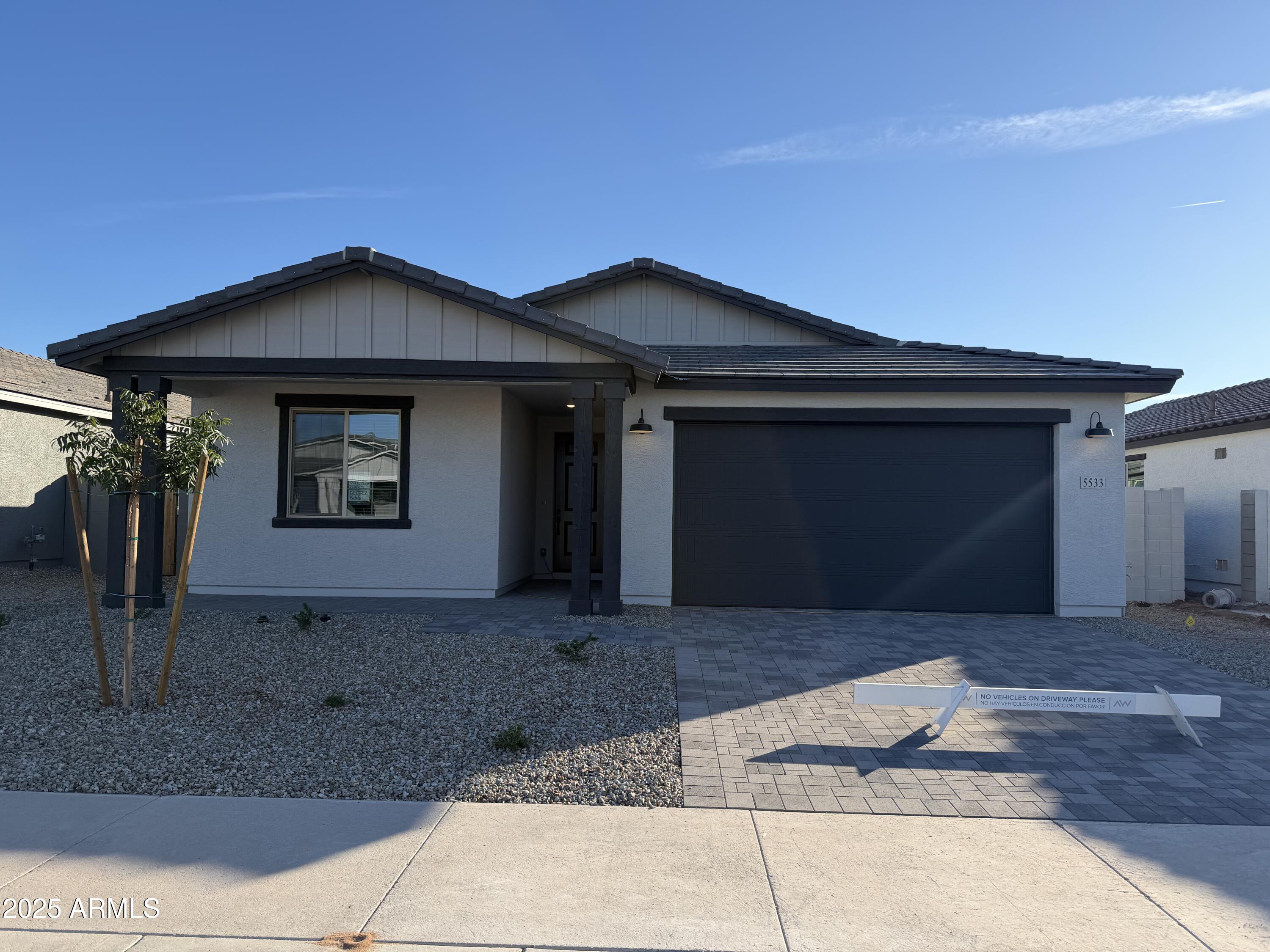 5533 West Buist Avenue Laveen, AZ 85339 - Photo 2 of 42 a front view of a house with porch