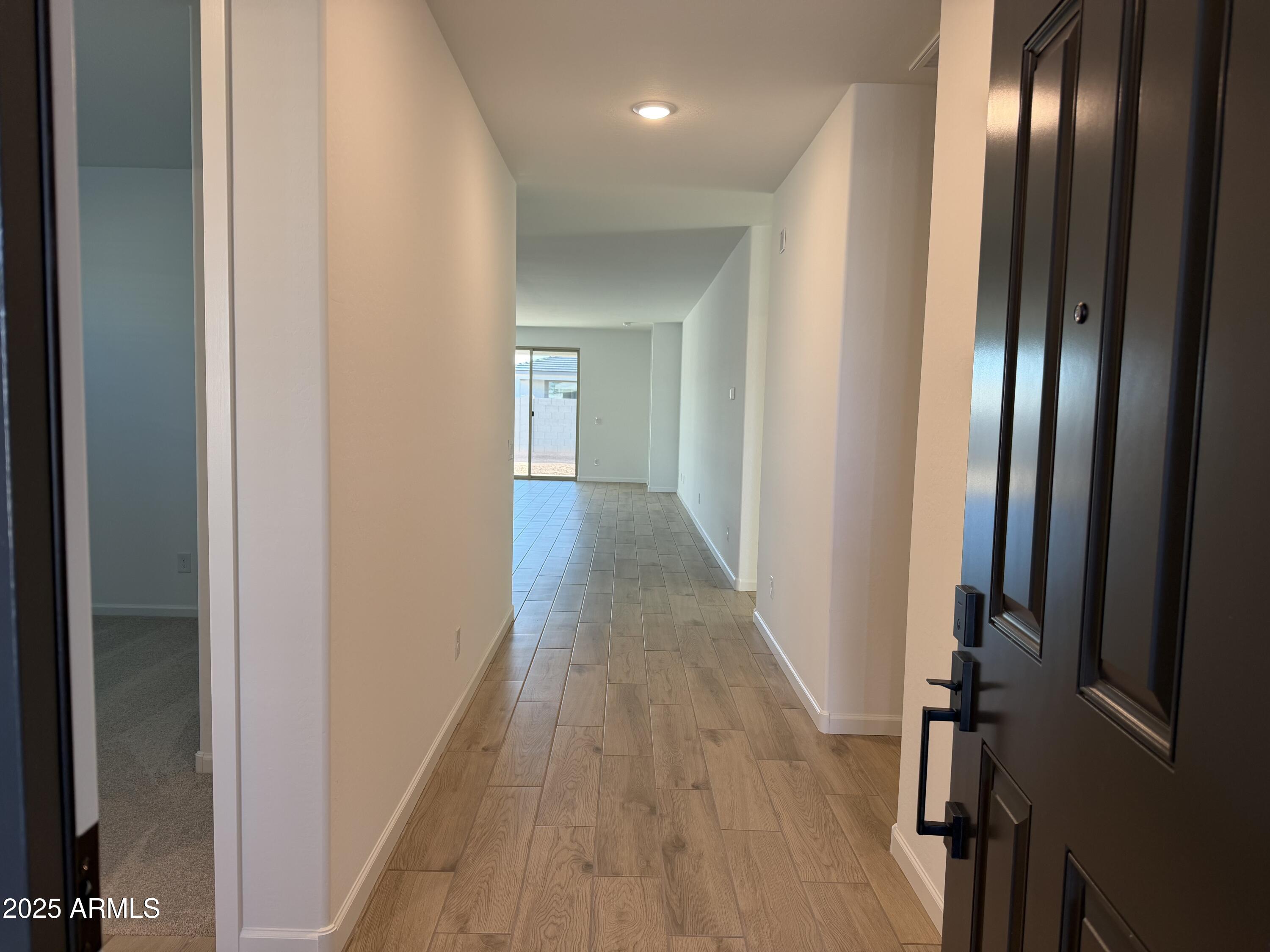5533 West Buist Avenue Laveen, AZ 85339 - Photo 3 of 42 a view of a hallway with wooden floor