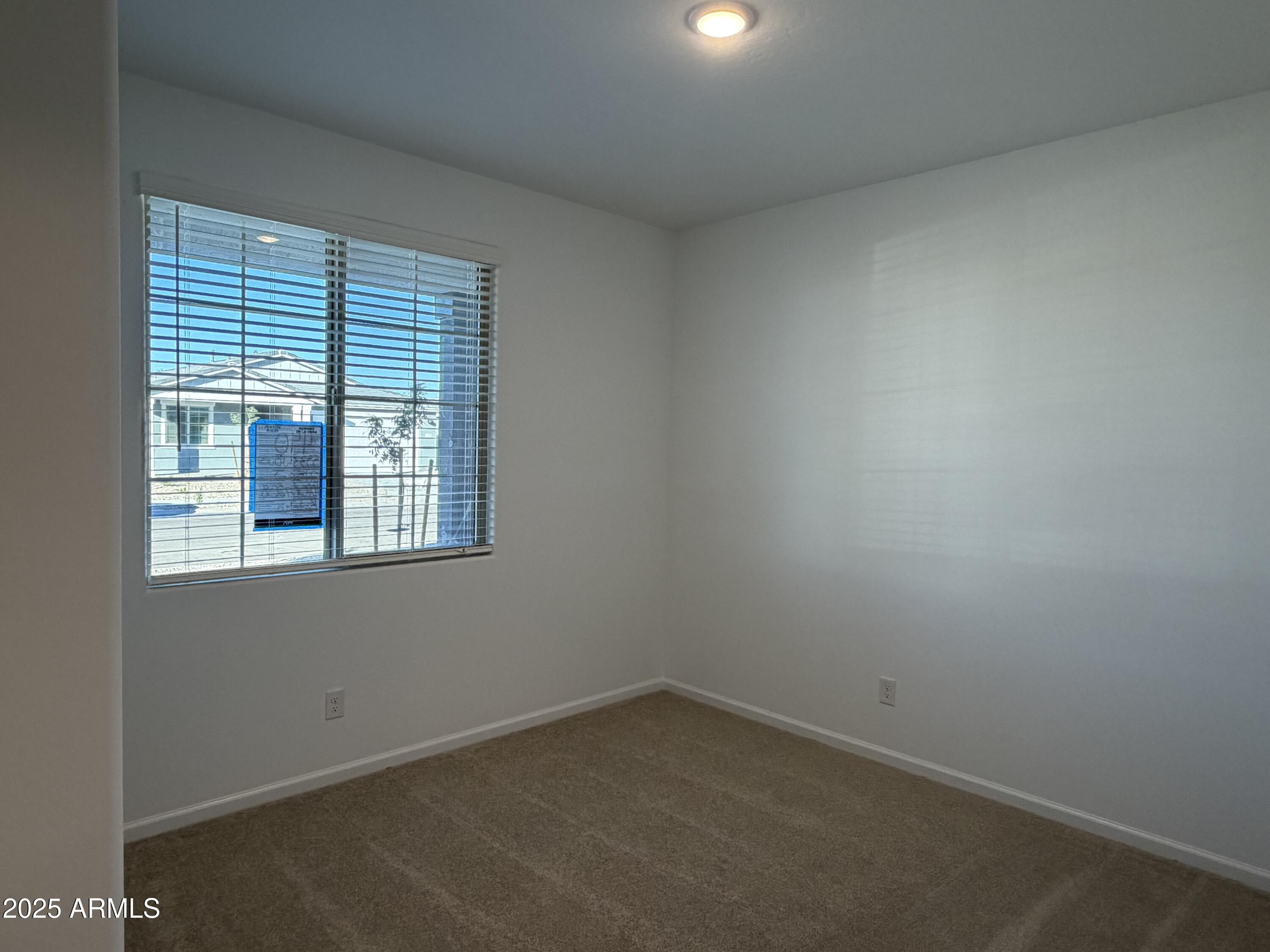 5533 West Buist Avenue Laveen, AZ 85339 - Photo 4 of 42 an empty room with a window