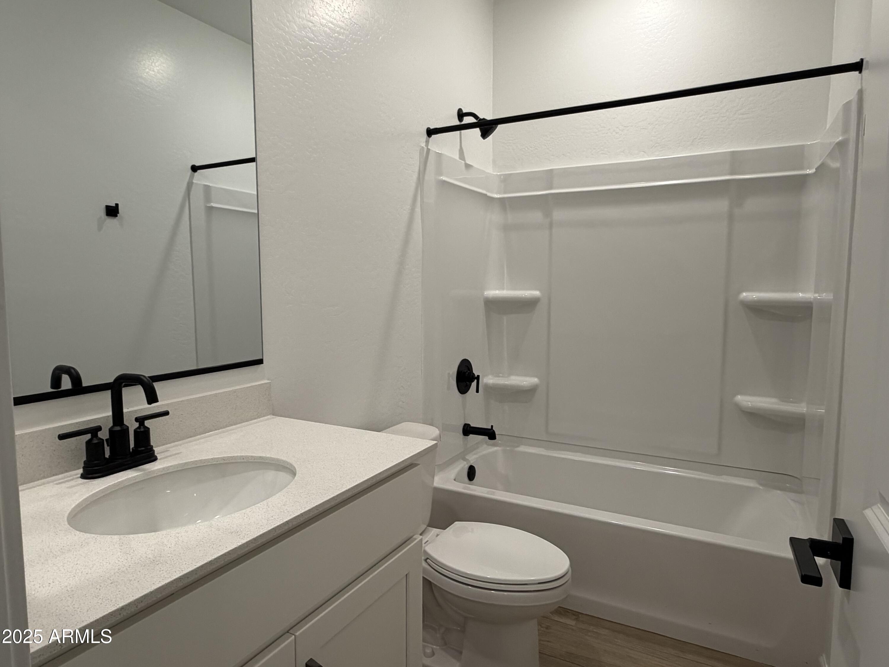 5533 West Buist Avenue Laveen, AZ 85339 - Photo 5 of 42 a bathroom with a sink and a mirror