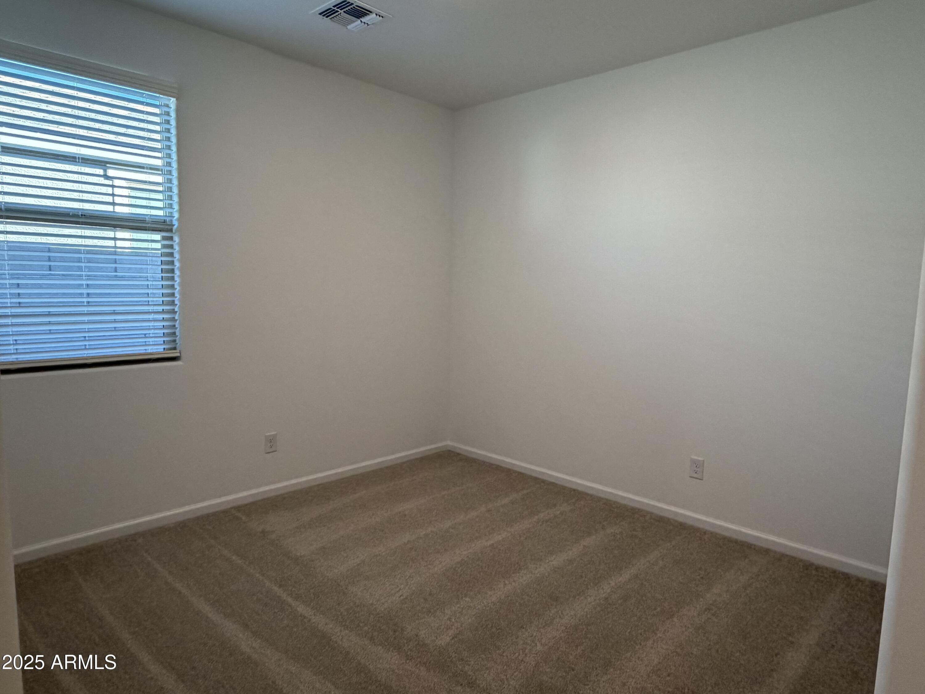 5533 West Buist Avenue Laveen, AZ 85339 - Photo 6 of 42 an empty room with a window