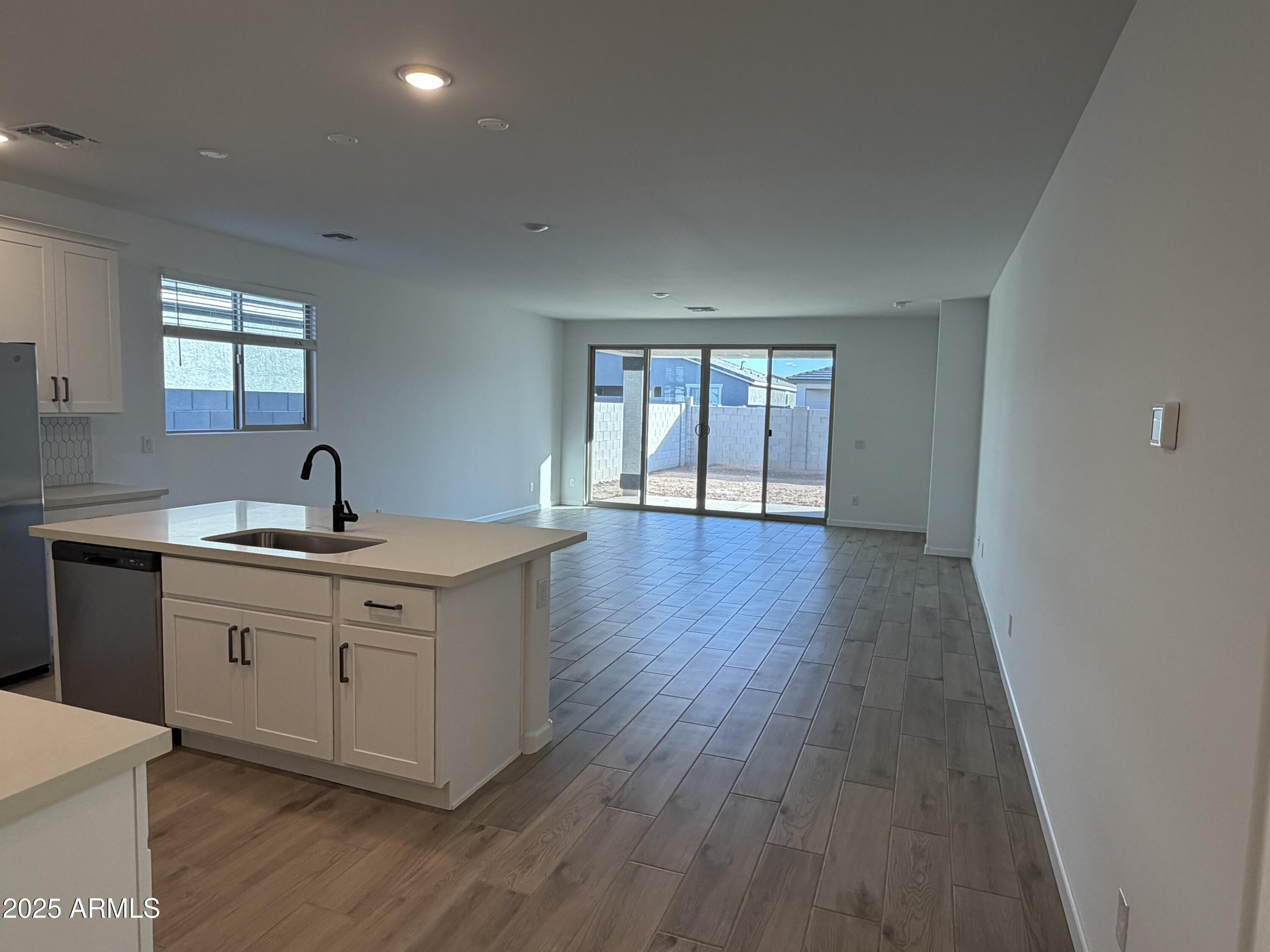 5533 West Buist Avenue Laveen, AZ 85339 - Photo 7 of 42 a hall with cabinets and wooden floor